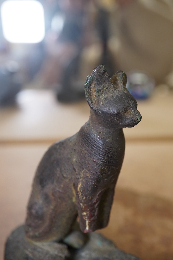 An Ancient bronze Egyptian cat, on separate base, 11.5cm in height. Condition - antique condition